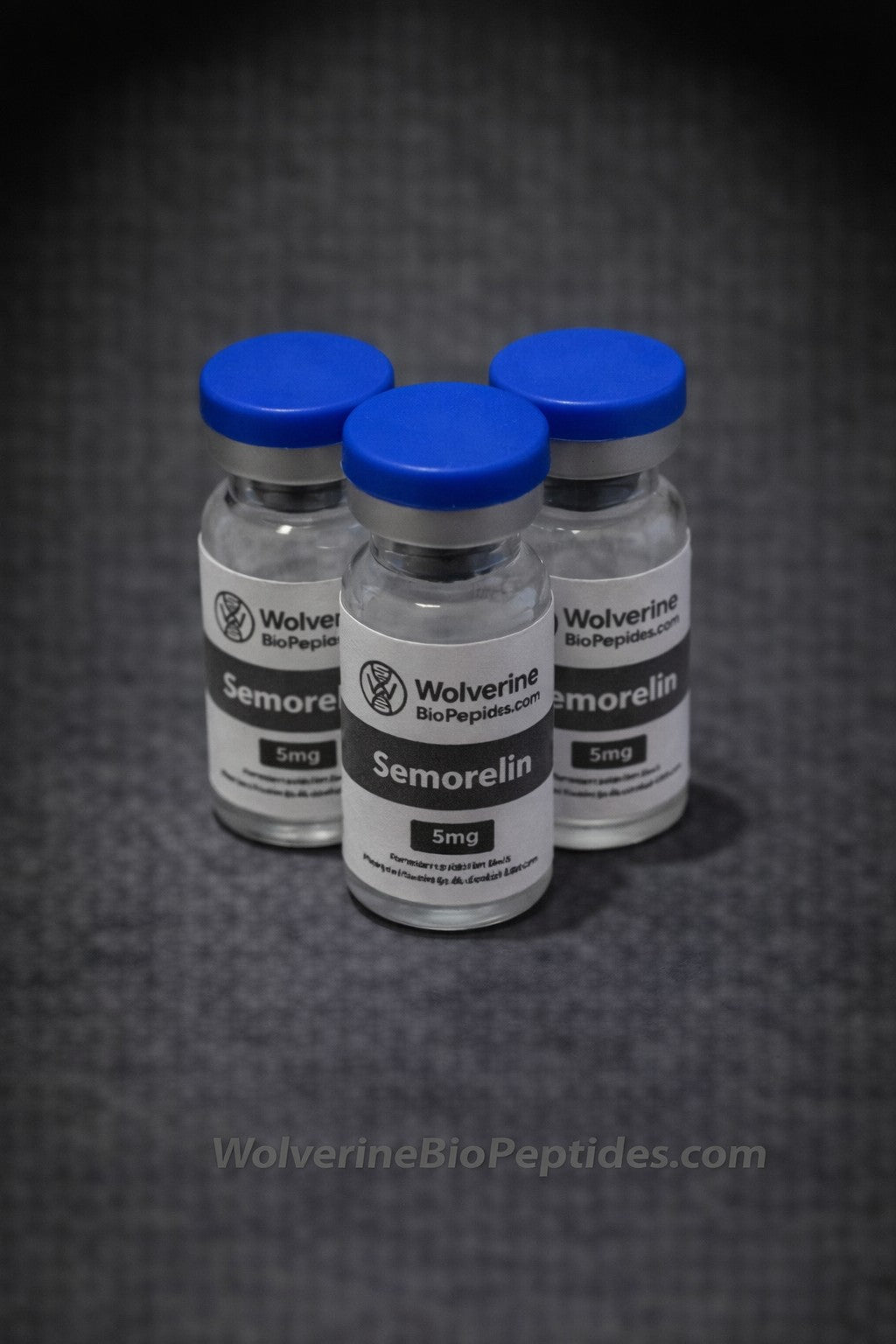 Three vials of Semorelin with blue caps on a dark textured background