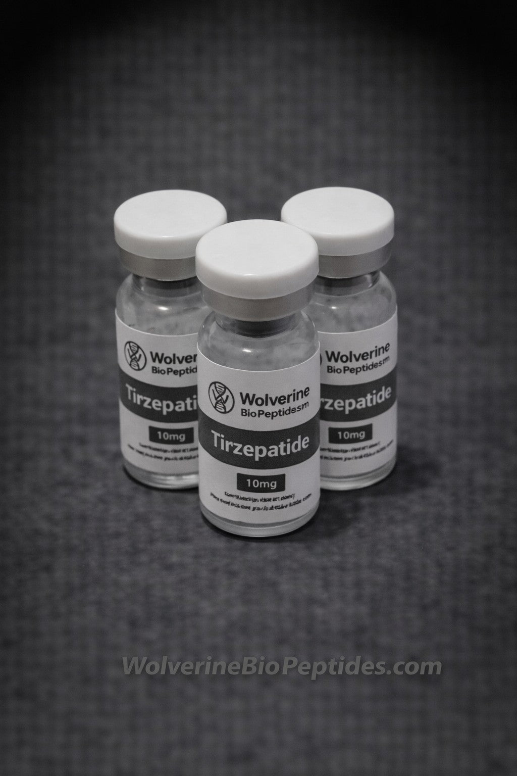 Three vials of Wolverine BioPeptides Tirzepatide on a dark background